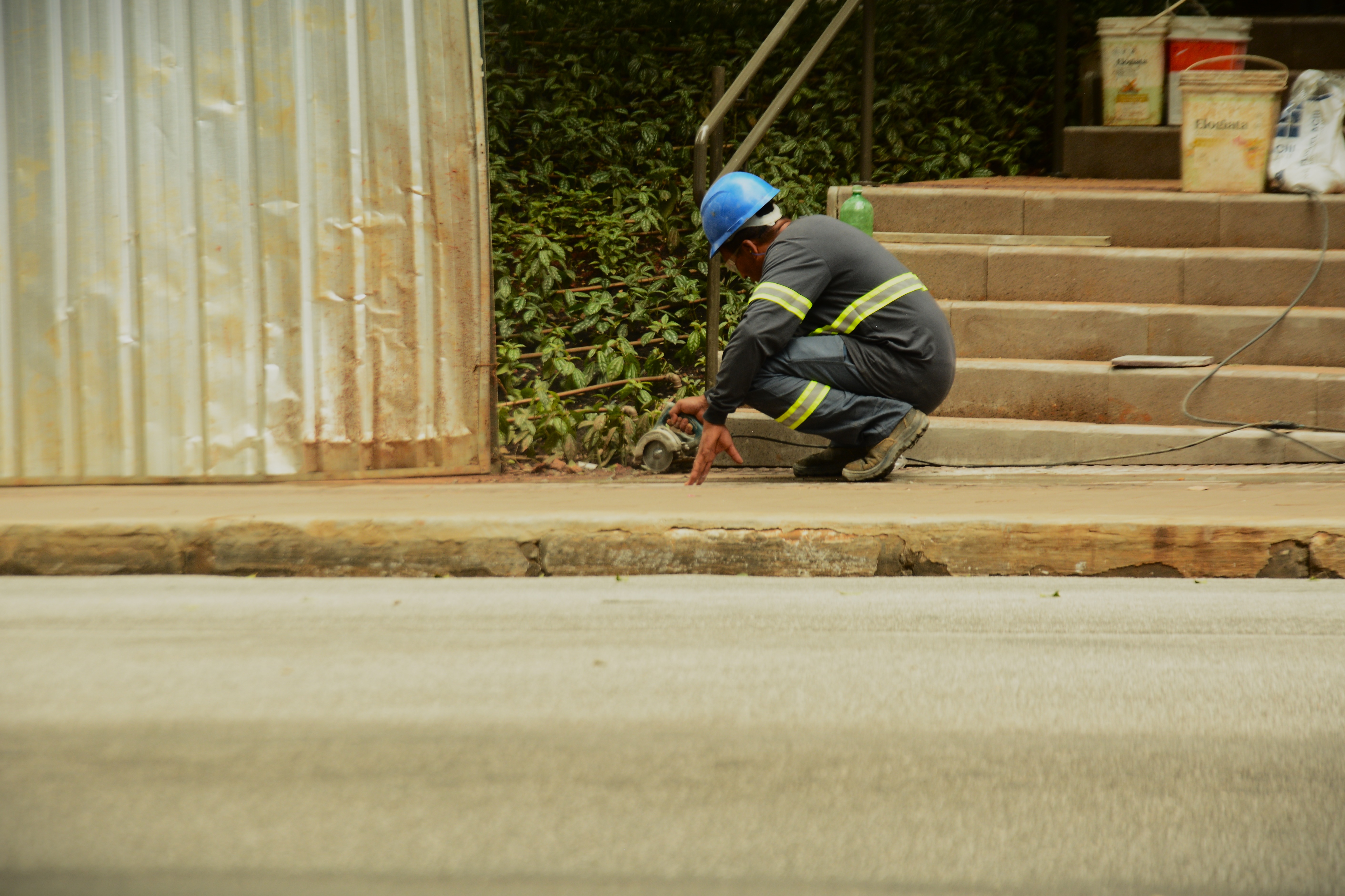 Um construtor serra algo no chão - Foto: Heitor Landim / Agenzia